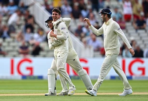 Dan Lawrence of England celebrates taking the wicket of Will Young of New Zealand with team mates James Bracey and Dominic Sibley during day two of...
