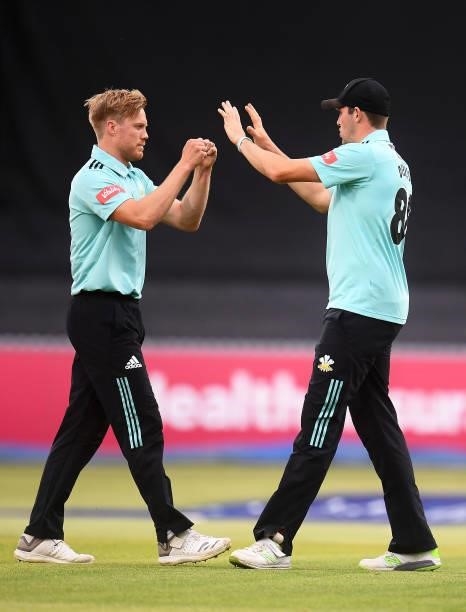 Matt Dunn of Surrey celebrates with team mate Jamie Overton after taking the wicket of Will Smeed of Somerset during the Vitality T20 Blast match...
