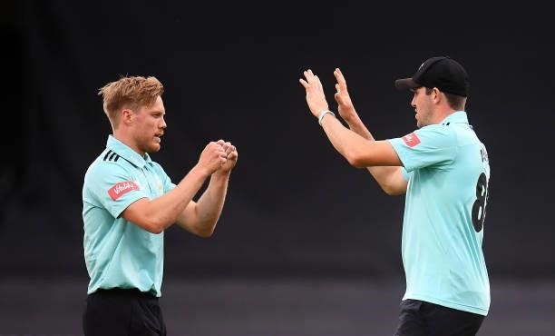 Matt Dunn of Surrey celebrates with team mate Jamie Overton after taking the wicket of Will Smeed of Somerset during the Vitality T20 Blast match...