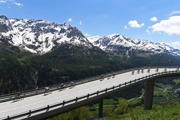 The Peloton passing through a bridge in Gotthardpass during the 84th Tour de Suisse 2021, Stage 6 a 130,1km stage from Andermatt to Disentis/Sedrun...