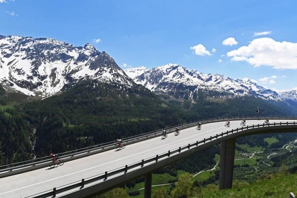 Stefan Bissegger of Switzerland and Team EF Education - Nippo Black Points Jersey & The Peloton passing through a bridge in Gotthardpass during the...