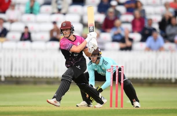 Tom Abell of Somerset plays a shot as Jamie Smith of Surrey looks on during the Vitality T20 Blast match between Somerset and Surrey at The Cooper...
