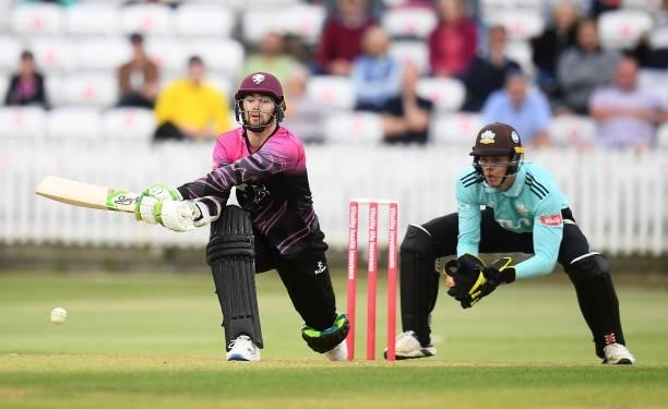 Eddie Byrom of Somerset plays a shot as Jamie Smith of Surrey looks on during the Vitality T20 Blast match between Somerset and Surrey at The Cooper...