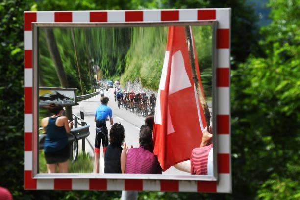 Reflection of The Peloton during the 84th Tour de Suisse 2021, Stage 6 a 130,1km stage from Andermatt to Disentis/Sedrun 1413m / Mirror / Fans /...