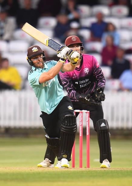 Laurie Evans of Surrey plays a shot as Tom Banton of Somerset looks on during the Vitality T20 Blast match between Somerset and Surrey at The Cooper...