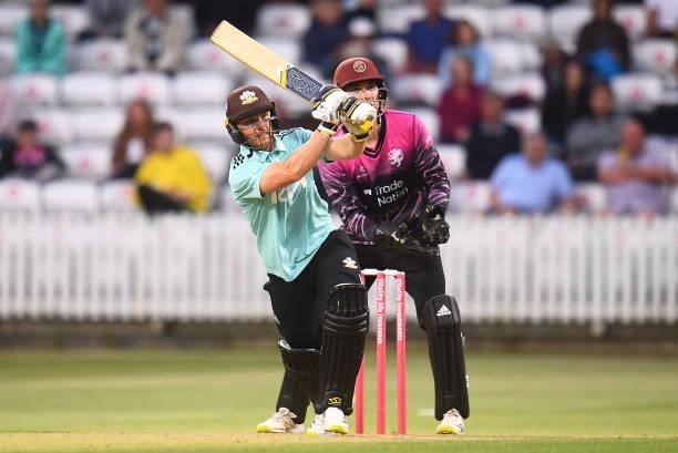 Laurie Evans of Surrey plays a shot as Tom Banton of Somerset looks on during the Vitality T20 Blast match between Somerset and Surrey at The Cooper...