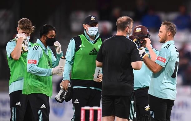 Laurie Evans of Surrey receives medical attention after being hit from a bouncer by Marchant De Lange of Somerset during the Vitality T20 Blast match...