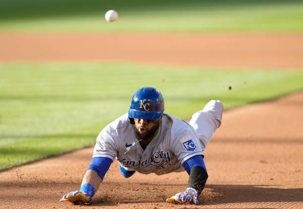Carlos Santana of the Kansas City Royals dives back into first base safe ahead of the throw against the Oakland Athletics in the top of the first...