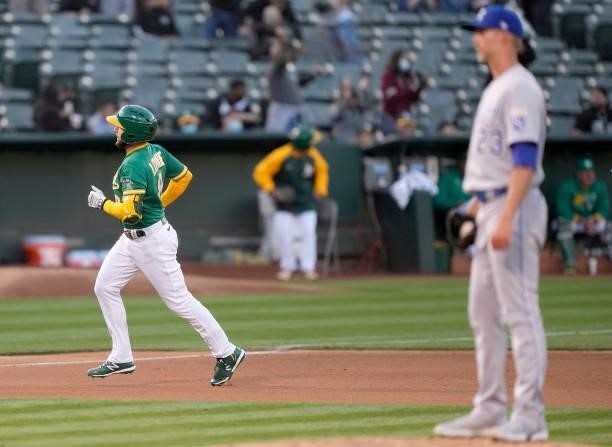 Jed Lowrie of the Oakland Athletics trots around the bases after hitting a solo home run off of Mike Minor of the Kansas City Royals in the bottom of...