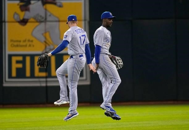 Hunter Dozier and Michael A. Taylor of the Kansas City Royals celebrates defeating the Oakland Athletics 6-1 at RingCentral Coliseum on June 10, 2021...