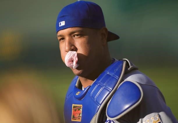 Salvador Perez of the Kansas City Royals runs in from the bullpen blowing bubbles with bubble gum prior to the start of his game against the Oakland...