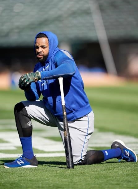 Carlos Santana of the Kansas City Royals on one knee looking on during batting practice prior to the start of his game against the Oakland Athletics...