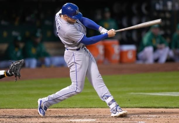 Hunter Dozier of the Kansas City Royals hits an RBI double scoring Andrew Benintendi against the Oakland Athletics in the top of the seventh inning...