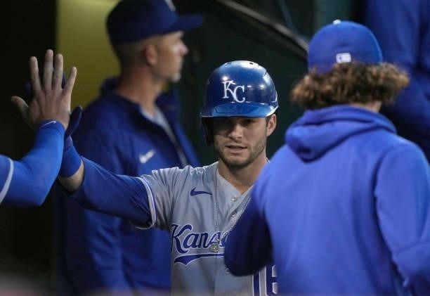 Andrew Benintendi of the Kansas City Royals is congratulated by teammates after he scored against the Oakland Athletics in the top of the seventh...