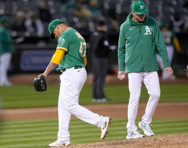 Pitcher Frankie Montas of the Oakland Athletics walks back to the dugout head down after manager Bob Melvin takes the ball from him taking him out of...