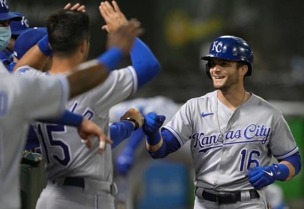 Andrew Benintendi of the Kansas City Royals is congratulated by teammates after he hit a solo home run against the Oakland Athletics in the top of...