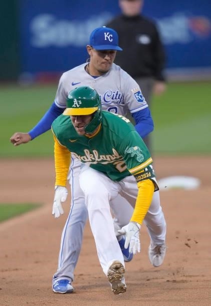 Stephen Piscotty of the Oakland Athletics gets caught in a rundown and tagged out by Nicky Lopez of the Kansas City Royals in the bottom of the fifth...