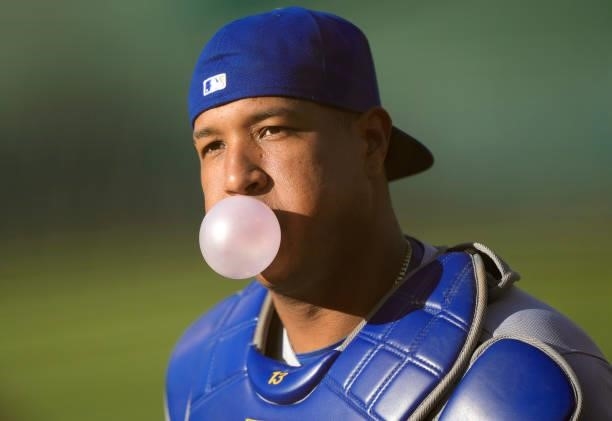 Salvador Perez of the Kansas City Royals runs in from the bullpen blowing bubbles with bubble gum prior to the start of his game against the Oakland...