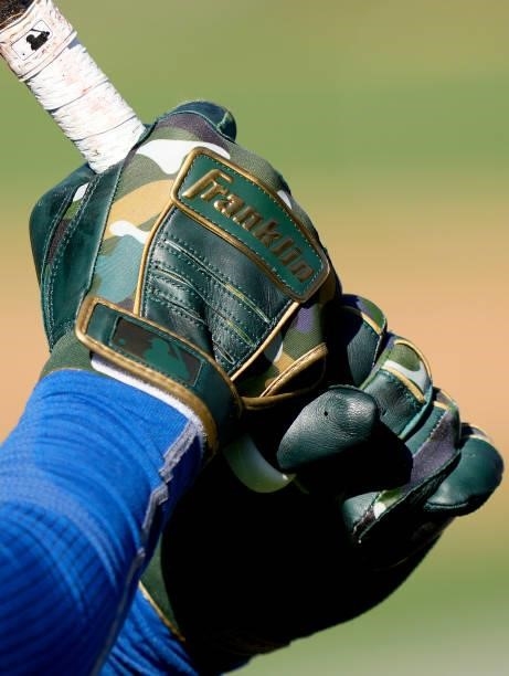 Detailed view of the Franklin batting gloves worn by Carlos Santana of the Kansas City Royals during batting practice prior to the start of his game...