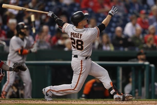Buster Posey of the San Francisco Giants hits a home run against the Washington Nationals during the fourth inning at Nationals Park on June 11, 2021...