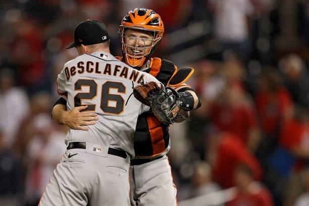 Starting pitcher Anthony DeSclafani of the San Francisco Giants celebrates with catcher Buster Posey after defeating the Washington Nationals at...