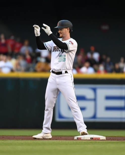 Pavin Smith of the Arizona Diamondbacks gestures to his dugout after hitting a double against the Los Angeles Angels during the second inning at...