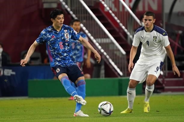 Shogo Taniguchi of Japan takes on Dejan Joveljic of Serbia during the international friendly match between Japan and Serbia at Noevir Stadium Kobe on...