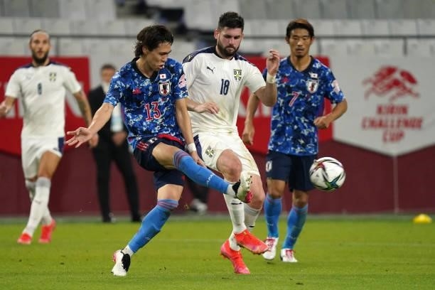 Kento Hashimoto of Japan and Milan Makaric of Serbia compete for the ball during the international friendly match between Japan and Serbia at Noevir...
