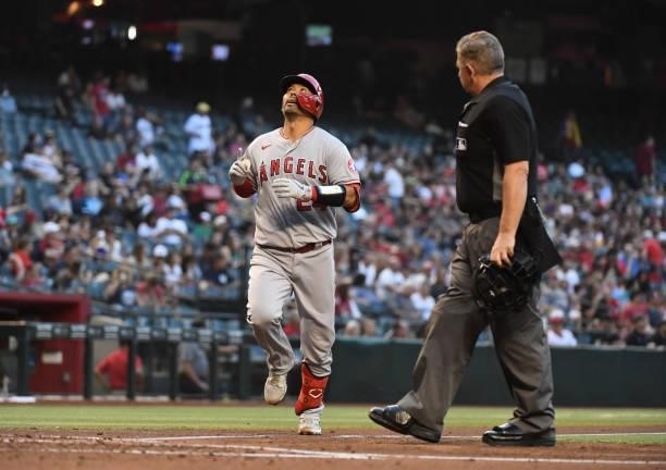 Kurt Suzuki of the Los Angeles Angels crosses home plate after hitting a solo home run off of Merrill Kelly of the Arizona Diamondbacks during the...