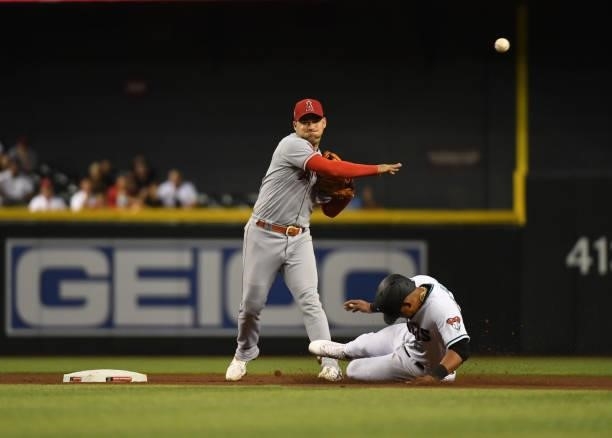 Jose Iglesias of the Los Angeles Angels attempts to turn a double play on a ground ball hit by Pavin Smith of the Arizona Diamondbacks as Eduardo...