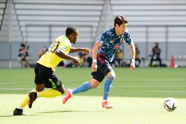 Hiroki Sakai of Japan U-24 takes on Kevaughn Isaacs of Jamaica during the international friendly match between Japan U-24 and Jamaica at the Toyota...