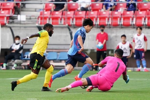 Yuki Soma of Japan U-24 and Dillon Barnes of Jamaica compete for the ball during the international friendly match between Japan U-24 and Jamaica at...