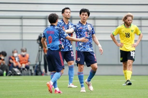 Koji Miyoshi, Maya Yoshida and Wataru Endo of Japan celebrate their 4-0 victory in the international friendly match between Japan U-24 and Jamaica at...