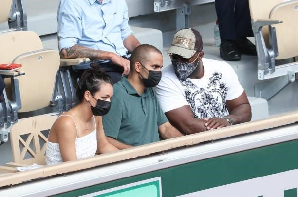 Tony Parker, his girlfriend Alize Lim and Teddy Riner attend the men's semifinals during day 13 of the 2021 Roland-Garros, French Open, a Grand Slam...
