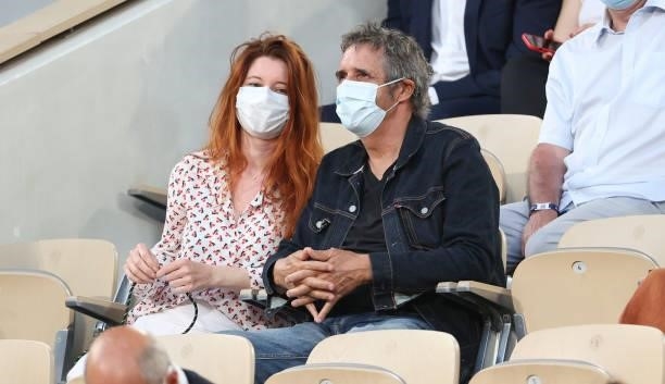 Julien Clerc and his wife Helene Gremillon attend the men's semifinals during day 13 of the 2021 Roland-Garros, French Open, a Grand Slam tennis...