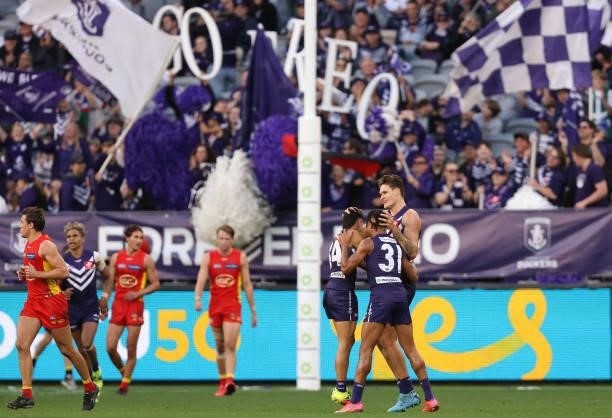 Rory Lobb of the Dockers celebrates a goal with Joel Western and Brandon Walker during the round 13 AFL match between the Fremantle Dockers and the...