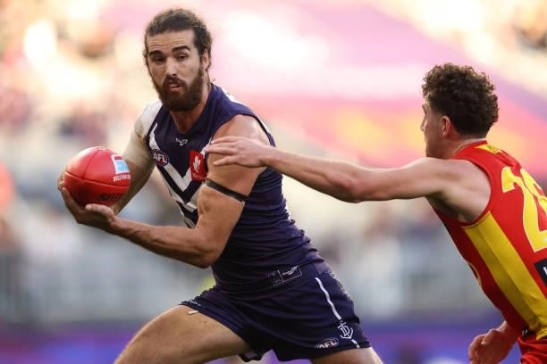Alex Pearce of the Dockers looks to break away from Sam Flanders of the Suns during the round 13 AFL match between the Fremantle Dockers and the Gold...