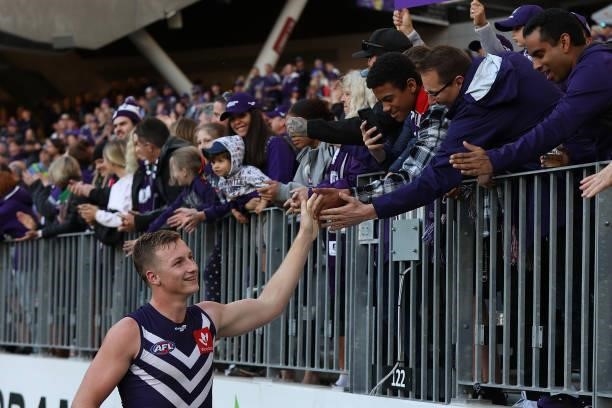 Josh Treacy of the Dockers celebrates with spectators after winning the round 13 AFL match between the Fremantle Dockers and the Gold Coast Suns at...