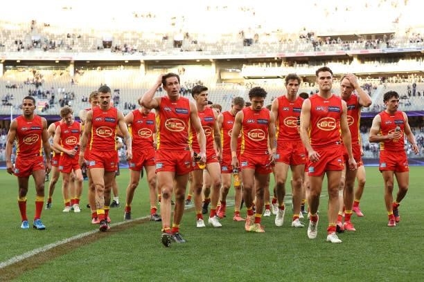 The Suns walk from the field after being defeated during the round 13 AFL match between the Fremantle Dockers and the Gold Coast Suns at Optus...