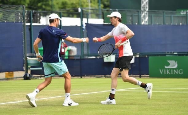 John- Patrick Smith and Matthew Ebden of Australia react as they win a game point in the men's doubles final match against Matt Reid of Australia and...