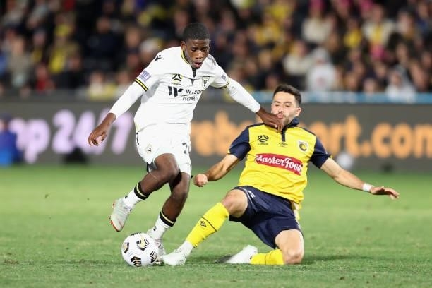 Charles M'Mombwa of Macarthur is contested by Stefan Nigro of the Mariners during the A-League Elimination Final match between Central Coast Mariners...