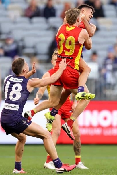 Joel Western of the Dockers and Nick Holman of the Suns contest for a mark during the round 13 AFL match between the Fremantle Dockers and the Gold...