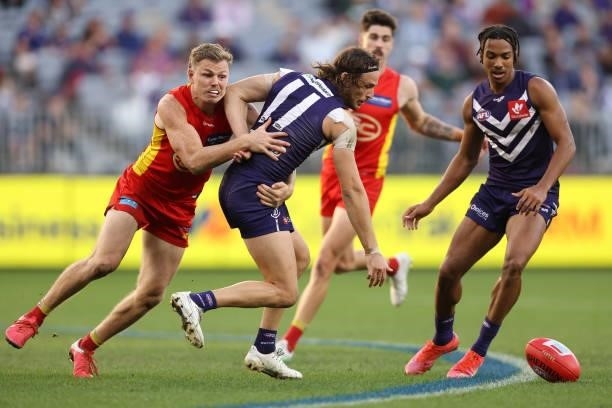 Nick Holman of the Suns and James Aish of the Dockers contest for the ball during the round 13 AFL match between the Fremantle Dockers and the Gold...
