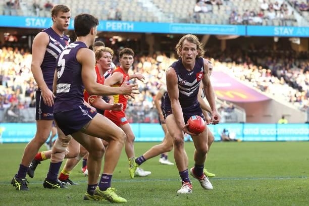 David Mundy of the Dockers handballs during the round 13 AFL match between the Fremantle Dockers and the Gold Coast Suns at Optus Stadium on June 12,...