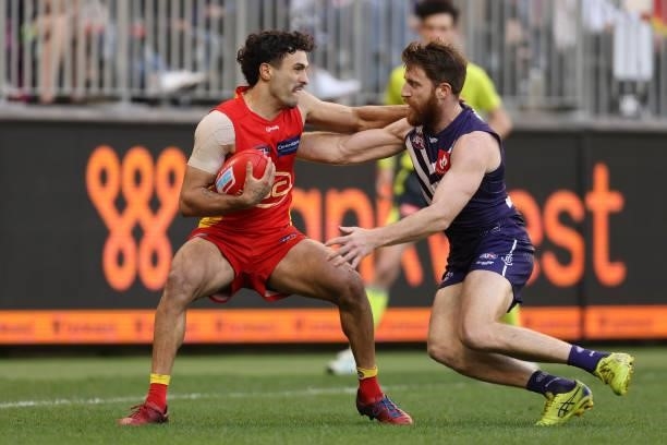 Reece Conca of the Dockers tackles Izak Rankine of the Suns during the round 13 AFL match between the Fremantle Dockers and the Gold Coast Suns at...