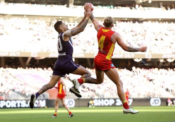 Brandon Ellis of the Suns intercepts the mark against Michael Walters of the Dockers during the round 13 AFL match between the Fremantle Dockers and...