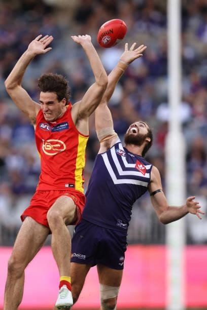Ben King of the Suns and Alex Pearce of the Dockers contest for the ball during the round 13 AFL match between the Fremantle Dockers and the Gold...