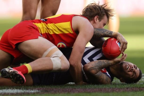 Jack Lukosius of the Suns tackles Michael Walters of the Dockers during the round 13 AFL match between the Fremantle Dockers and the Gold Coast Suns...