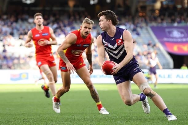 Blake Acres of the Dockers looks to pass the ball during the round 13 AFL match between the Fremantle Dockers and the Gold Coast Suns at Optus...