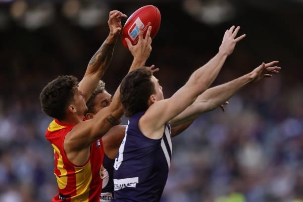 Sean Lemmens of the Suns contests for a mark during the round 13 AFL match between the Fremantle Dockers and the Gold Coast Suns at Optus Stadium on...